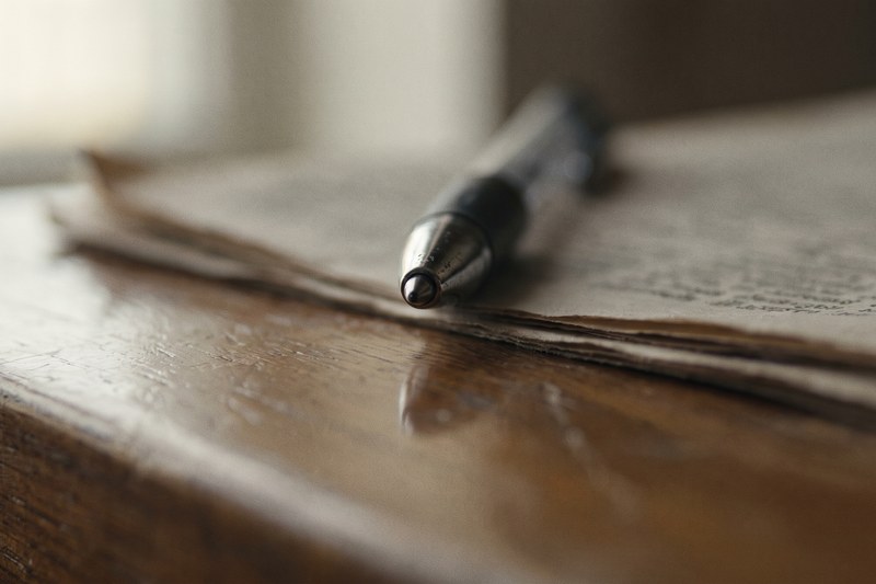 A builder purchase contract and a resale real estate contract side by side on a desk