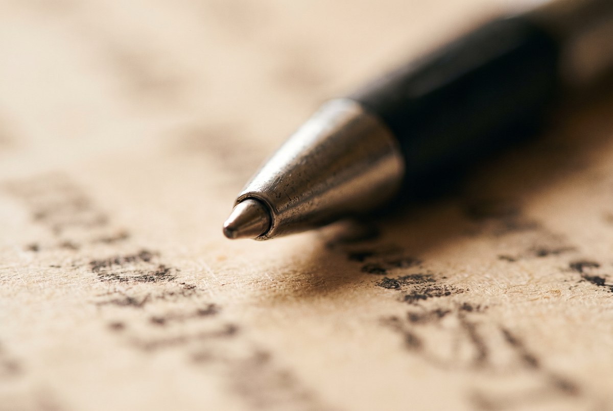 A pen resting on a contract document, shallow depth of field