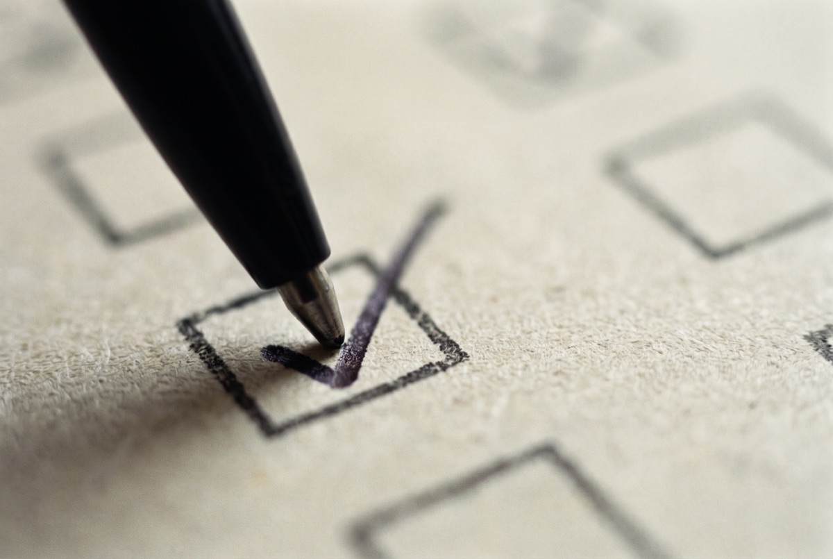 A checklist being checked off with a pen