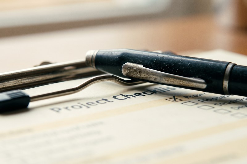 A checklist clipboard resting on a desk