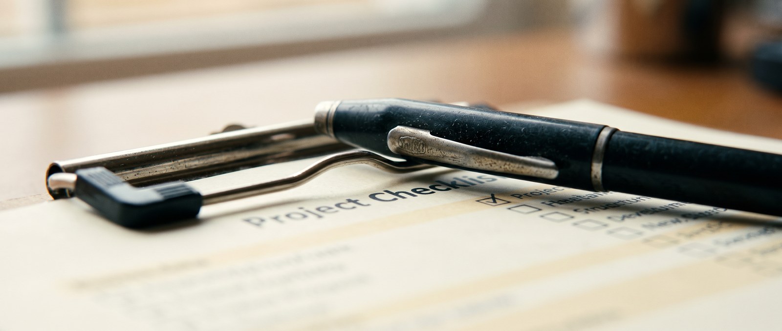 A checklist clipboard resting on a desk