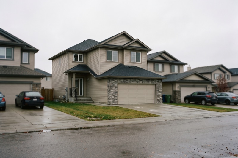 Finished home exterior with covered veranda and pool
