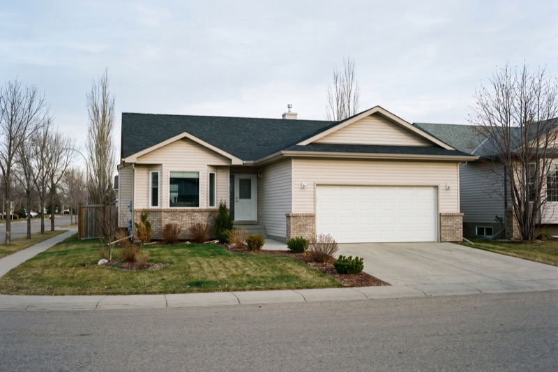 Modern two-storey home exterior at dusk with landscaped yard