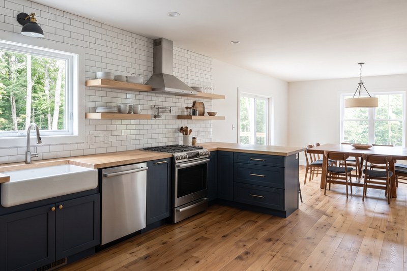 A renovated kitchen with new countertops and a for-sale sign visible through the window