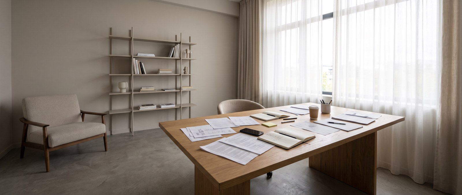 A person on the phone reviewing a new-home warranty booklet